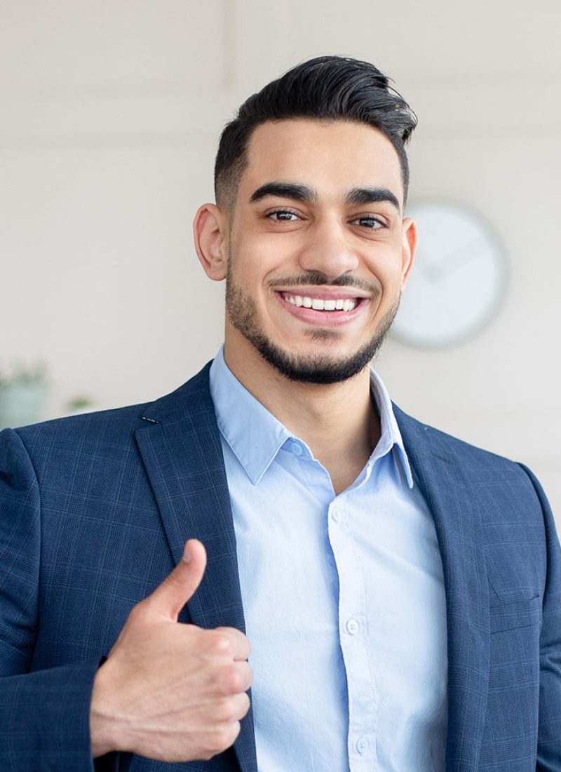 smiling-arab-businessman-holding-computer-showing-PAUEEHC.jpg